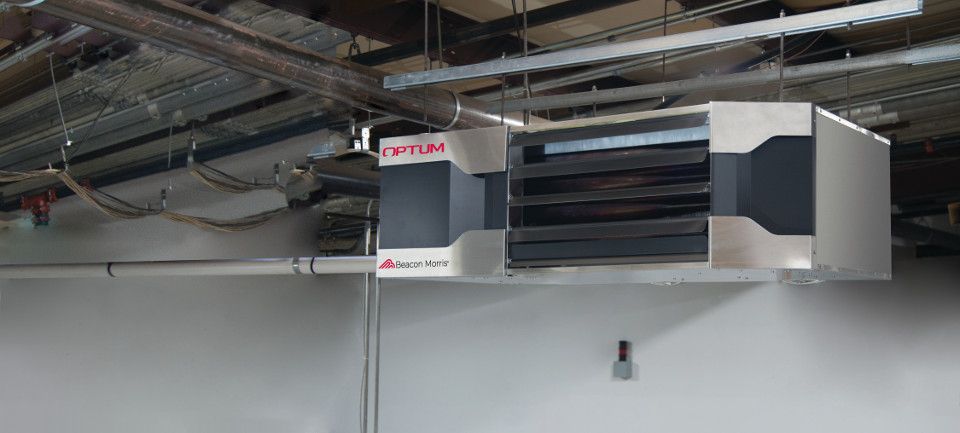 Optum unit heater hanging from the ceiling in a workshop
